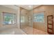 Large walk-in shower with glass enclosure and beige mosaic tile at 345 Madison Dr, Sarasota, FL 34236