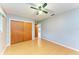 Bright bedroom with wood floors, double doors, and ceiling fan at 3601 Yardley N Ave, St Petersburg, FL 33713