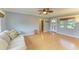 Light and airy living room with light hardwood floors and ceiling fan at 3601 Yardley N Ave, St Petersburg, FL 33713