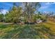 Spacious backyard with lush greenery and mature trees at 3651 Country Place Blvd, Sarasota, FL 34233