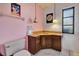 Small bathroom with corner vanity and pink walls at 3651 Country Place Blvd, Sarasota, FL 34233