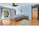 Spacious bedroom with hardwood floors, blue walls and ceiling fan at 3651 Country Place Blvd, Sarasota, FL 34233