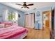 Bedroom with pink bedding and wood floors at 3651 Country Place Blvd, Sarasota, FL 34233