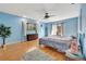 Main bedroom with light blue walls, hardwood floors, and patio access at 3651 Country Place Blvd, Sarasota, FL 34233