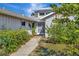 Front entrance with a walkway and lush landscaping at 3651 Country Place Blvd, Sarasota, FL 34233