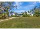 House featuring a spacious lawn and walkway at 3651 Country Place Blvd, Sarasota, FL 34233