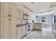 Kitchen features white cabinets, double oven, and view to dining area at 3651 Country Place Blvd, Sarasota, FL 34233