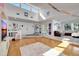 Sunlit living room with hardwood floors and views into kitchen and entry at 3651 Country Place Blvd, Sarasota, FL 34233