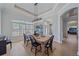 Elegant dining room with a farmhouse table and a built-in wine bar at 366 S Creek Ct, Osprey, FL 34229