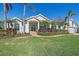 Two-story house with a lush green lawn, palm trees, and a brick driveway at 366 S Creek Ct, Osprey, FL 34229