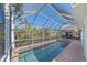 Refreshing pool and spa with a screened enclosure at 366 S Creek Ct, Osprey, FL 34229