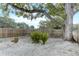 Backyard with large tree, rock ground cover, and wood fence at 3822 75Th E Ter, Sarasota, FL 34243