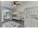 ' bedroom with twin bunk beds and large window at 3822 75Th E Ter, Sarasota, FL 34243