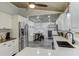 Modern kitchen with stainless steel appliances and white cabinets at 3822 75Th E Ter, Sarasota, FL 34243