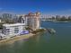 Aerial view of waterfront property with multiple buildings and a marina at 400 Golden Gate Pt # 11, Sarasota, FL 34236