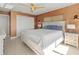 Bright bedroom with white bed and louvered doors at 400 Golden Gate Pt # 11, Sarasota, FL 34236