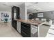 Modern kitchen with granite island and open concept design at 400 Golden Gate Pt # 11, Sarasota, FL 34236