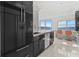 Modern kitchen with dark cabinetry and granite countertops at 400 Golden Gate Pt # 11, Sarasota, FL 34236