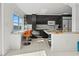 Sleek kitchen featuring dark cabinetry and granite countertops at 400 Golden Gate Pt # 11, Sarasota, FL 34236