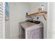 Neat laundry room with washer, dryer, and shelving at 400 Golden Gate Pt # 11, Sarasota, FL 34236