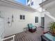 Relaxing patio with seating and outdoor shower at 400 Golden Gate Pt # 11, Sarasota, FL 34236