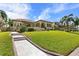 Landscaped backyard with stone pathway leading to a beautiful home at 4110 Commodore Blvd, Cortez, FL 34215