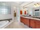 Bathroom boasts double vanity and a large soaking tub at 4110 Commodore Blvd, Cortez, FL 34215