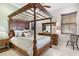Bedroom with a canopy bed and water views at 4110 Commodore Blvd, Cortez, FL 34215