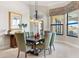 Bright dining room with large windows, water views and seating for six at 4110 Commodore Blvd, Cortez, FL 34215
