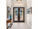 Elegant entryway with double doors, ornate glass, and wood accents at 4110 Commodore Blvd, Cortez, FL 34215