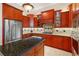 Spacious kitchen featuring stainless steel appliances and granite countertops at 4110 Commodore Blvd, Cortez, FL 34215