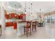 Gourmet kitchen with granite counters, wood cabinets, and breakfast bar at 4110 Commodore Blvd, Cortez, FL 34215