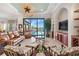 Spacious living room with water views, leather furniture, and built-ins at 4110 Commodore Blvd, Cortez, FL 34215