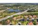 Aerial view of community featuring villas and lush landscaping near water at 4351 Trails Dr # 4-2, Sarasota, FL 34232