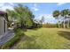 Spacious backyard with grassy lawn, deck, and mature trees at 4351 Trails Dr # 4-2, Sarasota, FL 34232