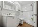 White bathroom vanity, bathtub, and hexagon tile accents at 4351 Trails Dr # 4-2, Sarasota, FL 34232