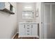 White bathroom vanity with granite countertop and large mirror at 4351 Trails Dr # 4-2, Sarasota, FL 34232