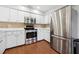 Stainless steel appliances and white cabinetry in this kitchen at 4351 Trails Dr # 4-2, Sarasota, FL 34232