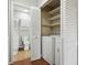 Stackable washer and dryer in closet with built-in shelves at 4351 Trails Dr # 4-2, Sarasota, FL 34232