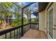 Screened porch with wooden deck overlooking backyard at 4351 Trails Dr # 4-2, Sarasota, FL 34232