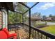 Screened porch with wooden deck and red chairs at 4351 Trails Dr # 4-2, Sarasota, FL 34232