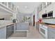 Modern kitchen with gray cabinets, granite counters, and stainless steel appliances at 4679 Country Manor Dr, Sarasota, FL 34233