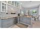 Modern kitchen with gray cabinets, granite counters, and stainless steel appliances at 4679 Country Manor Dr, Sarasota, FL 34233