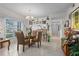 Charming dining area with a glass table and four chairs, near the kitchen at 4705 Sand Trap Street E Cir # 106, Bradenton, FL 34203