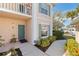 Inviting condo entry with a teal door and well-manicured landscaping at 4705 Sand Trap Street E Cir # 106, Bradenton, FL 34203