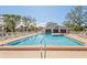 Inviting community pool with plenty of lounge chairs at 4705 Sand Trap Street E Cir # 106, Bradenton, FL 34203