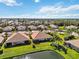 Aerial view of community with houses and pond at 4891 Maymont Park Cir, Bradenton, FL 34203