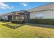 Screened patio and well-manicured lawn at 4891 Maymont Park Cir, Bradenton, FL 34203