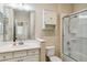 Bathroom with vanity, toilet, shower, and white cabinets at 4891 Maymont Park Cir, Bradenton, FL 34203