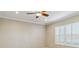 Spacious bedroom with crown molding, ceiling fan, and large window with shutters at 4891 Maymont Park Cir, Bradenton, FL 34203